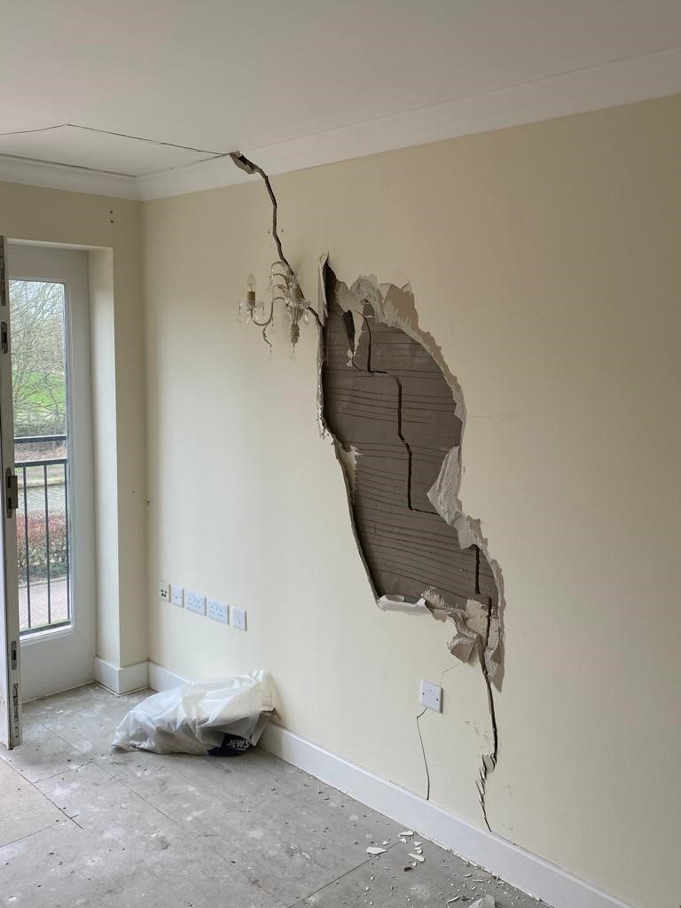 Crack in the wall of a house, showing deformation and movement monitoring