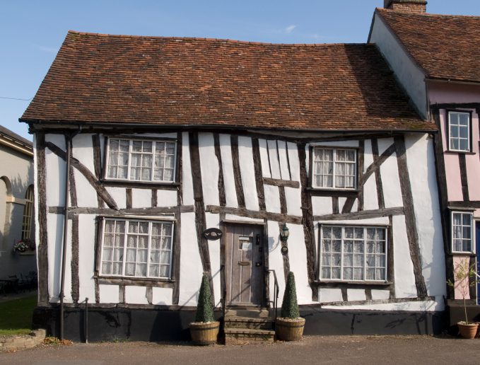 A thatch cottage-esqe house, which has slanted and become wonky due to subsidence